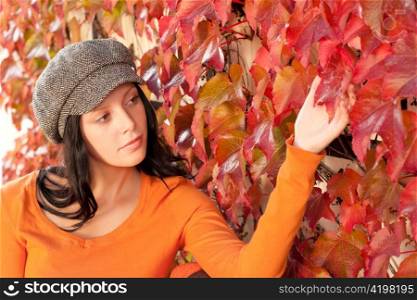 Autumn park scenery young woman relax touch leaf