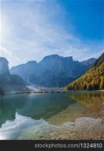 Autumn peaceful alpine lake Braies or Pragser Wildsee. Dolomites Alps, Italy, Europe. People unrecognizuble. Picturesque traveling, seasonal and nature beauty concept scene.