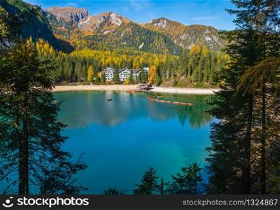 Autumn peaceful alpine lake Braies or Pragser Wildsee. Dolomites Alps, Italy, Europe. People unrecognizuble. Picturesque traveling, seasonal and nature beauty concept scene.