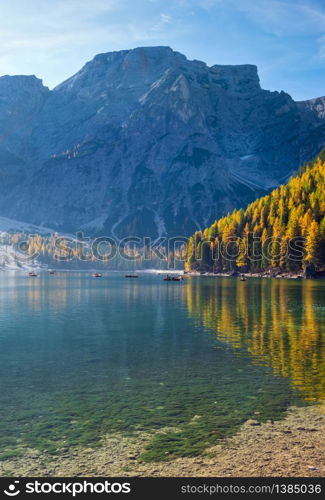 Autumn peaceful alpine lake Braies or Pragser Wildsee, South Tyrol, Dolomites Alps, Italy, Europe. Picturesque traveling, seasonal and nature beauty concept scene. People unrecognizable.