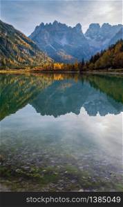 Autumn peaceful alpine lake Durrensee or Lago di Landro. Snow-capped Cristallo rocky mountain group behind, Dolomites, Italy, Europe. Picturesque traveling, seasonal and nature beauty concept scene.