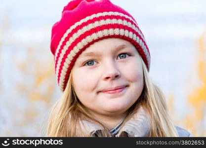 Autumn photo of beautiful girl in red hat