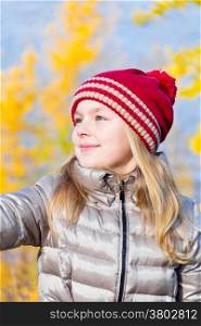 Autumn photo of beautiful girl in red hat