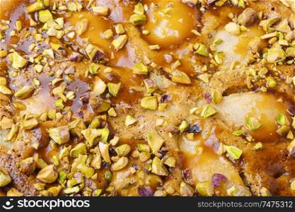 Autumn pie with pear and pistachio.Traditional autumn pie.Food background. Autumn pie with pear
