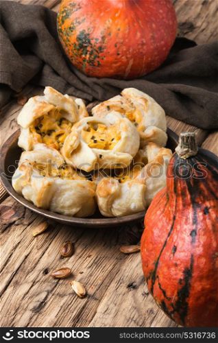 Autumn pie with pumpkin. autumn pumpkin bun on retro wood background