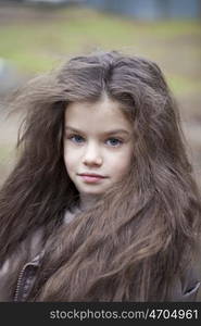 Autumn portrait of a beautiful young girl on the street