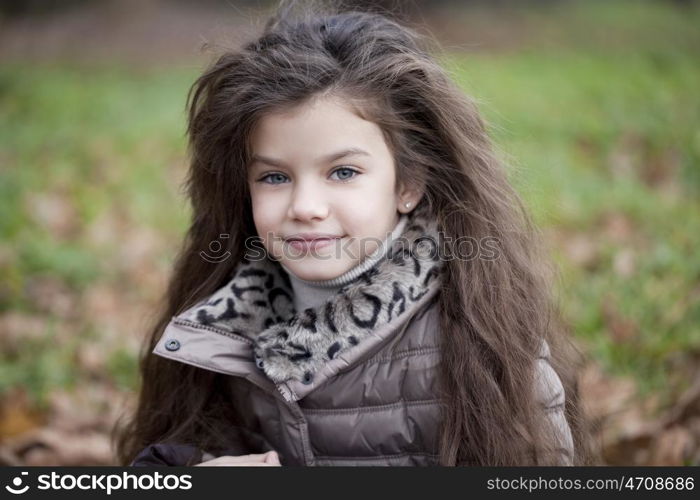 Autumn portrait of a beautiful young girl on the street