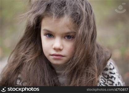 Autumn portrait of a beautiful young girl on the street