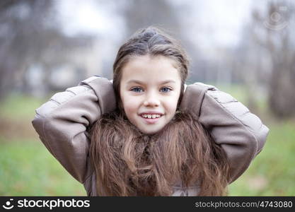 Autumn portrait of a beautiful young girl on the street