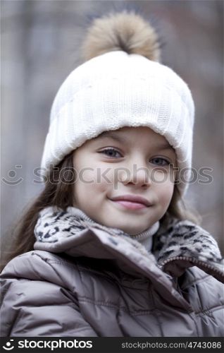 Autumn portrait of a beautiful young girl on the street