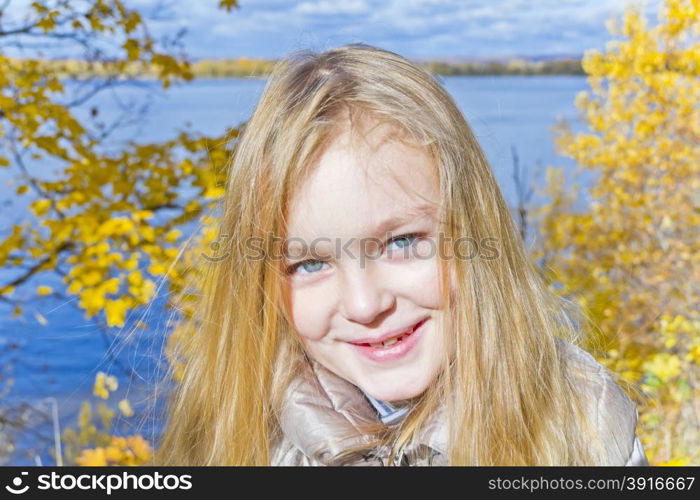 Autumn portrait of blond girl in sunlight