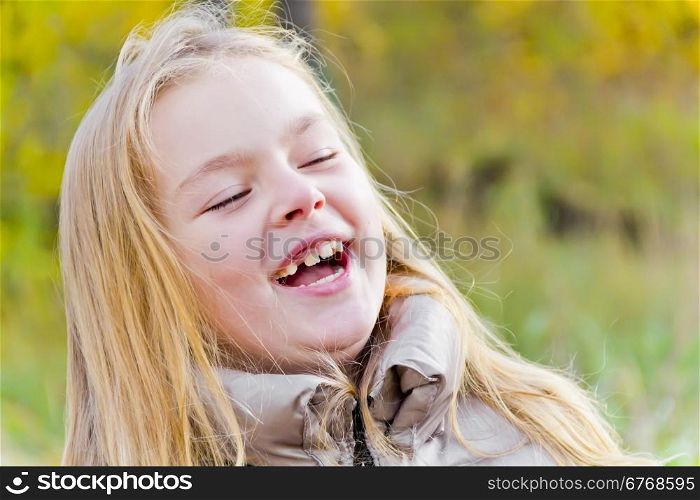 Autumn portrait of laugh girl in sunlight
