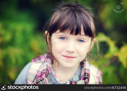 Autumn portrait of pretty brunette little girl
