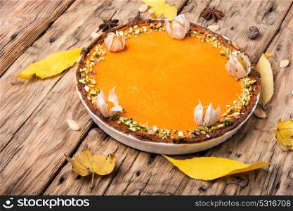 autumn pumpkin pie. rustic autumn pie from a pumpkin on a wooden background