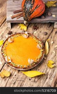 autumn pumpkin pie. rustic autumn pie from a pumpkin on a wooden background