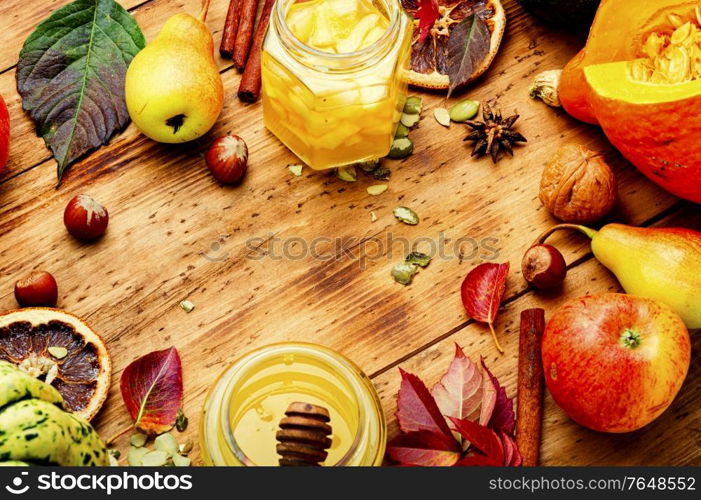 Autumn pumpkins and fruits with fallen leaves.Autumnal background. Autumn leaves,pumpkin and fruits