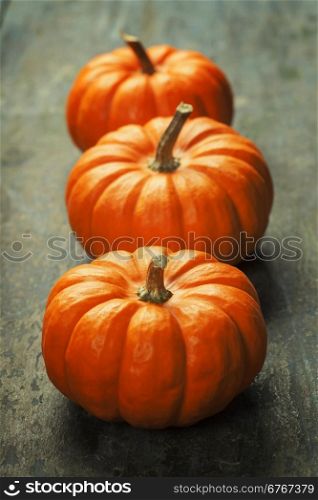 Autumn pumpkins on wooden board