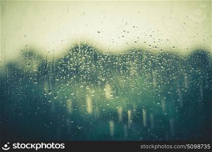Autumn rain water drops on window glass background.
