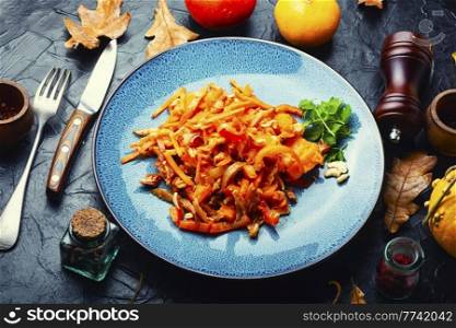 Autumn salad with spicy pig ears and pumpkin. Meat salad with pumpkin.