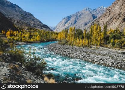 Autumn scene, blue turquoise water of Gilgit river flowing through Gupis surrounded by Hindu Kush mountain range, Ghizer, Gilgit-Baltistan, Pakistan.