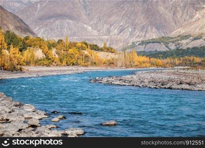 Autumn scene of blue water of Gilgit river flowing through Gupis, Ghizer, Gilgit Baltistan, Pakistan.