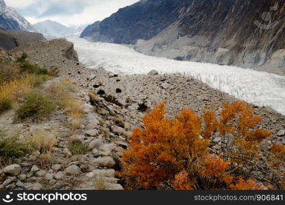 Autumn scene of Passu glacier surrounded by mountains in Karakoram range. Gojal Hunza. Gilgit Baltistan, Pakistan.