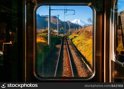 Autumn scenery along train tracks railroad through train window seen from driver room on Tokyo - Kawaguchiko route, Japan