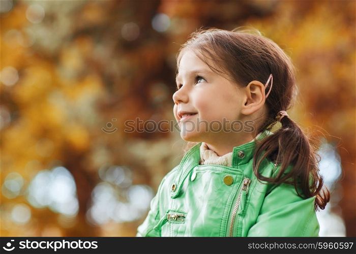 autumn, season, childhood, happiness and people concept - happy beautiful little girl portrait outdoors