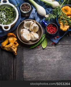 Autumn seasonal cooking ingredients with harvest vegetables, greens and mushrooms on dark rustic wooden background, top view