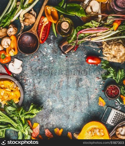 Autumn seasonal eating and cooking with pumpkin and fresh organic vegetables ingredients on rustic background, top view, frame