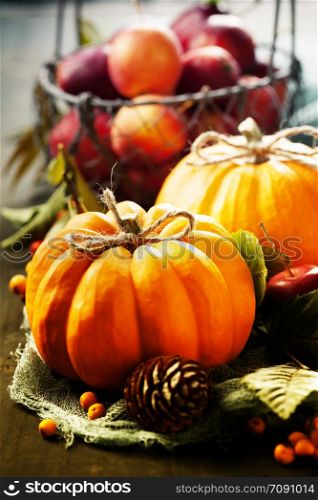 Autumn still life with pumpkins, apples and leaves. Autumn still life with pumpkins, apples and leaves on old wooden background