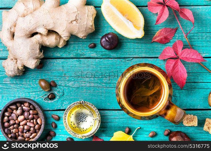 Autumn still life with tea. herbal autumn tea with ginger on an autumn background