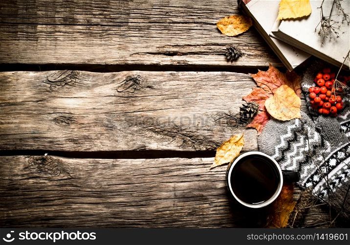 Autumn style. Coffee with an old books. On wooden background.. Autumn style. Coffee with an old books.