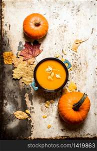 Autumn style. pumpkin soup with seeds. On rustic background.. Autumn style. pumpkin soup with seeds.