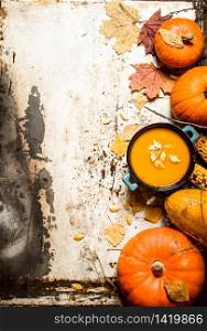 Autumn style. pumpkin soup with seeds. On rustic background.. Autumn style. pumpkin soup with seeds.
