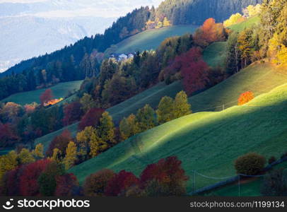 Autumn sunrise Santa Magdalena famous Italy Dolomites mountain village environs view in first sunlight. Picturesque traveling, seasonal and countryside beauty concept background.