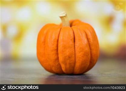 Autumn table setting with pumpkins holiday / Thanksgiving background decoration festive or halloween bokeh background