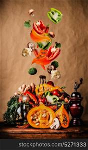 Autumn vegetables Falling in the basket on kitchen table. Flying food. Healthy Vegetarian Food , Eating and cooking
