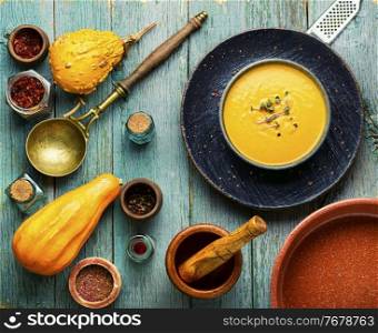Autumn vegetarian pumpkin cream soup.Pumpkin soup on wooden rustic table. Pumpkin soup and pumpkins