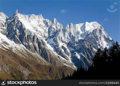Autumn view of snowcapped peaks in an alpine valley. Gran Jourasses (Mont Blanc massif), Val Veny, Courmayeur, Italy.