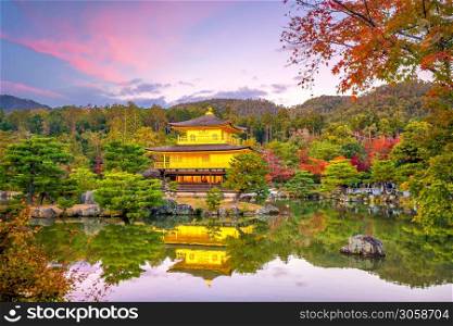 Autumn view of The Golden Pavilion of Kinkaku-ji temple in Kyoto, Japan at sunset
