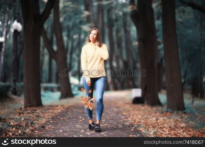 autumn view, people in the park on the background of autumn trees / beautiful autumn concept weather fall