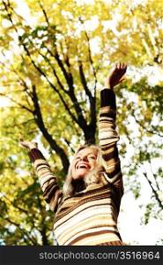 autumn woman hands in the air