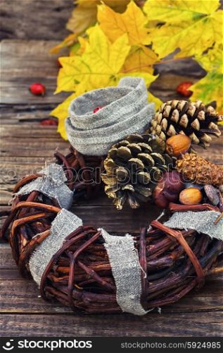 autumn wreath garland. their woven vine wreath decorated with pine cones and autumn acorns