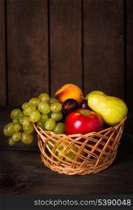 Autumnal fruits in the basket with sopyspace