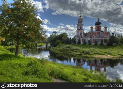 Autumnal Landscape with old Russian Church Reflected in the River