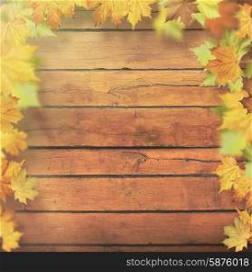 Autumnal leaves over old wooden desk, seasonal backgrounds