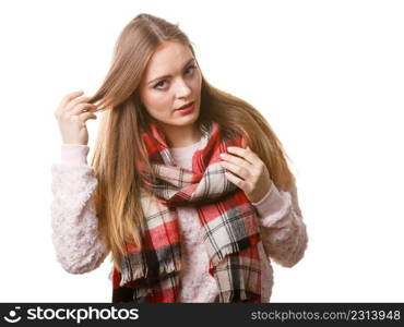 Autumnal outfit concept. Young long haired woman wearing warm autumn clothing woolen checked scarf isolated on white. Woman wearing woolen checked scarf warm autumn clothing