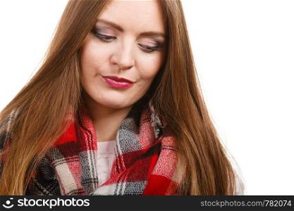Autumnal outfit concept. Young long haired woman wearing warm autumn clothing woolen checked scarf isolated on white. Woman wearing woolen checked scarf warm autumn clothing