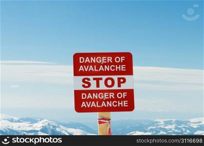 Avalanche sign and mountains at the background